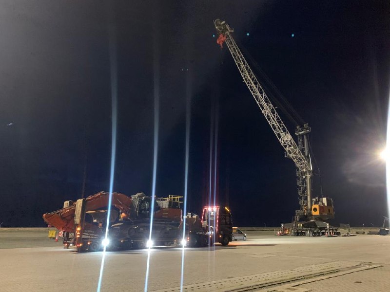 Dunkirk night crane-assisted machinery movement / low loader transport